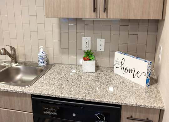 A kitchen counter with a sign that says