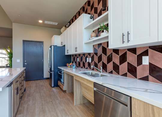 A kitchen with a blue refrigerator and wooden cabinets.
