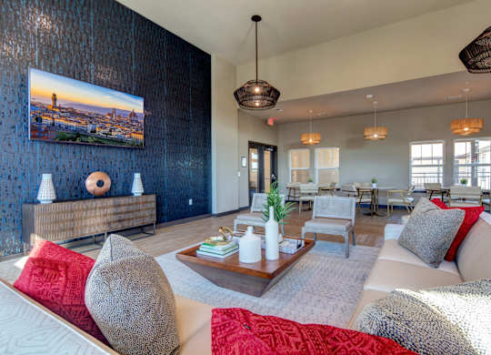 A living room with a large couch, a coffee table, and a painting on the wall.