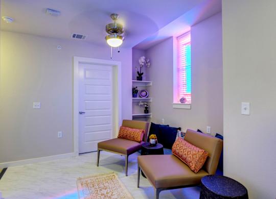 A living room with a brown couch and a white door.