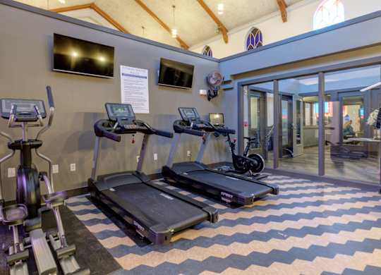 A gym with treadmills and exercise bikes.