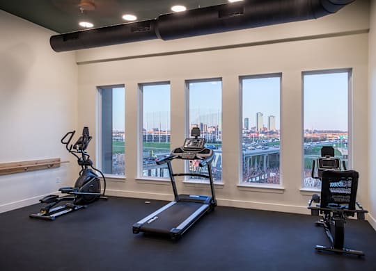 A gym with treadmills and exercise bikes.