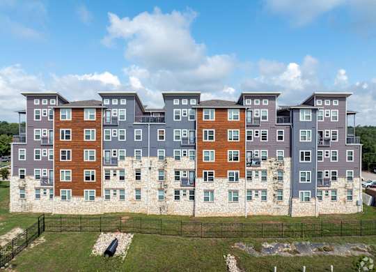 A large apartment complex with multiple buildings and balconies.