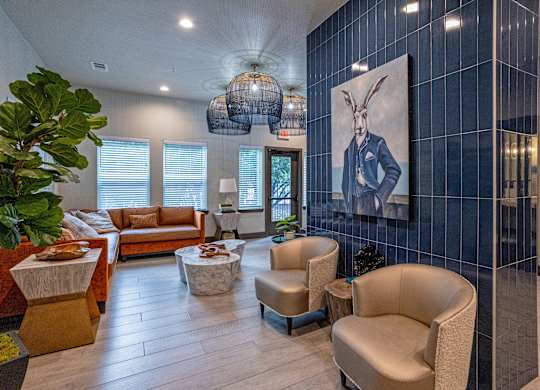 A living room with a large painting of a rabbit on the wall.