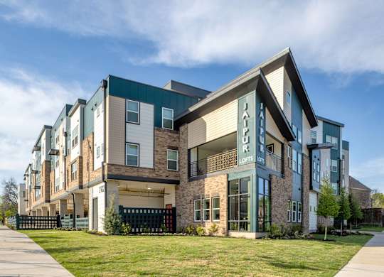 A modern apartment complex with a sign that reads "Happy Home".
