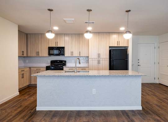 A kitchen with a white island in the middle.