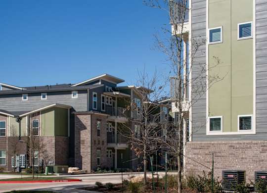 A modern building with a grey and green facade.