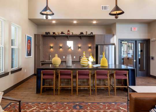 A dining area with a long table and chairs.