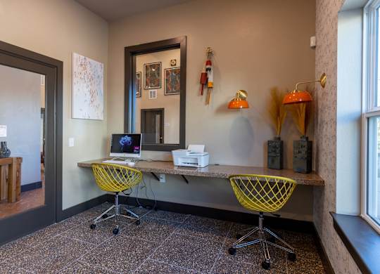 A room with a desk and chairs.