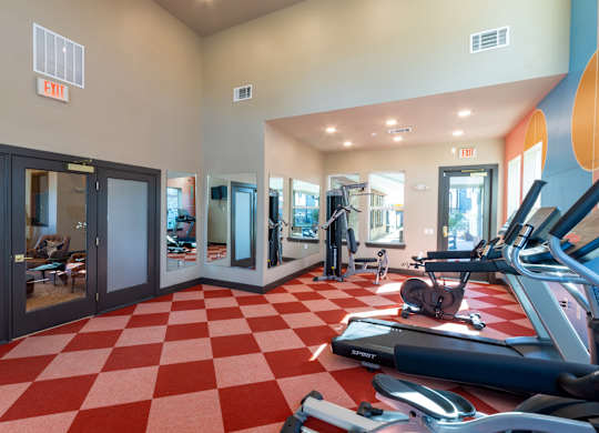 A gym with a red and white checkered floor.