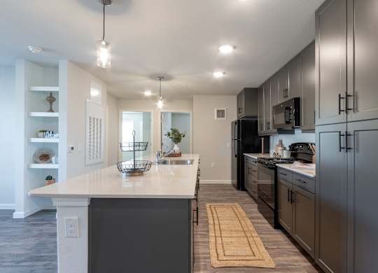 A modern kitchen with a large island and stainless steel appliances.