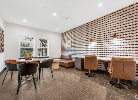 A room with a brown tiled floor and a wall with a patterned tile design.