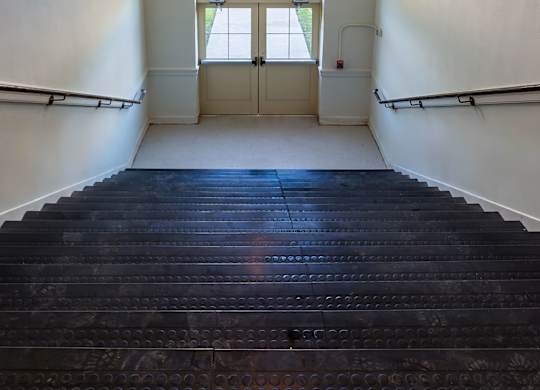 A staircase with a light hanging above it.