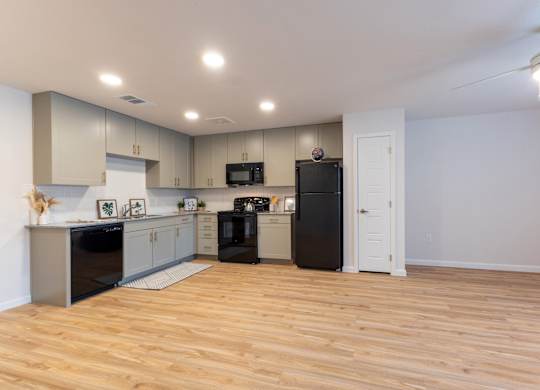 A kitchen with wooden floors and modern appliances.