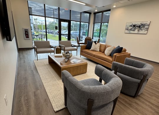 A modern waiting room with comfortable seating and a view of the outside.