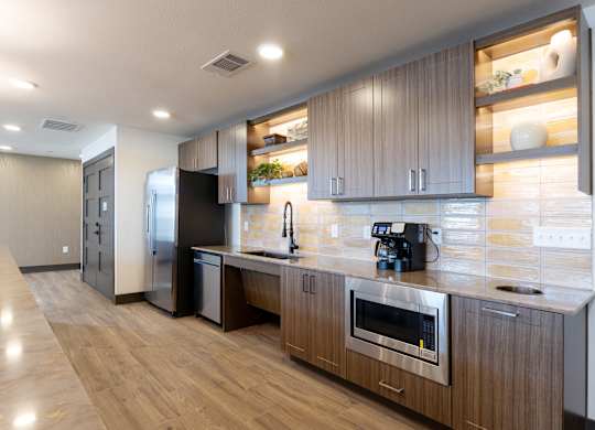 A modern kitchen with wooden cabinets and stainless steel appliances.