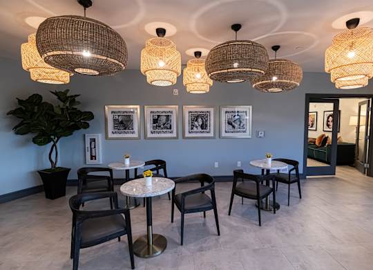 A room with a table and chairs and pictures on the wall.