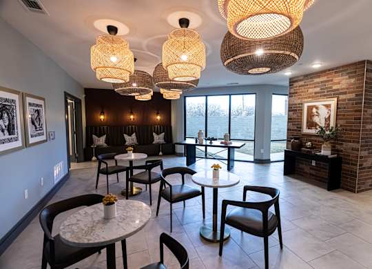 A room with a brick wall and a table with chairs.