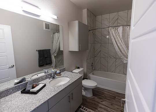 A bathroom with a toilet, sink, and shower.