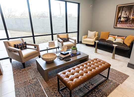 A living room with a large window and a view of a field.