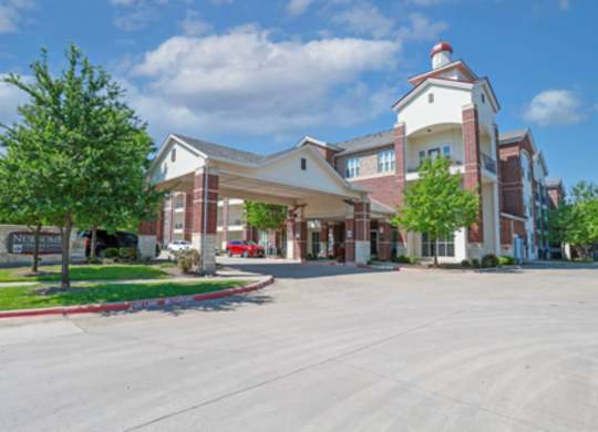 A large building with a red roof and a sign that says "Nursing Care".