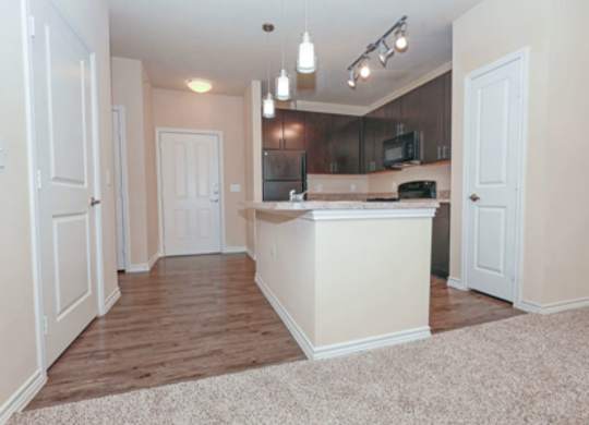 A kitchen area with a counter and cabinets.