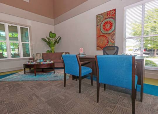 A blue chair sits in a room with a brown carpet.