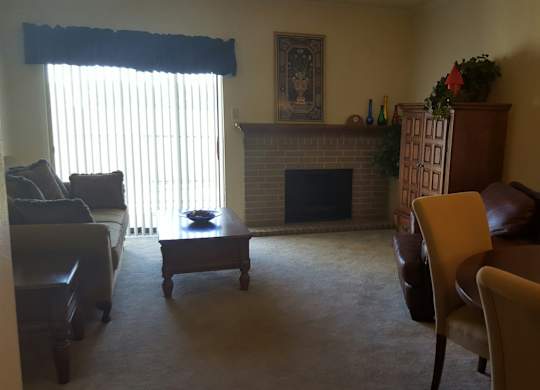 A living room with a fireplace and a couch.