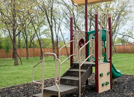A playground with a slide and a canopy.