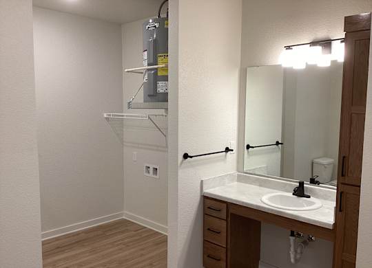 A bathroom with a sink, mirror, and medicine cabinet.