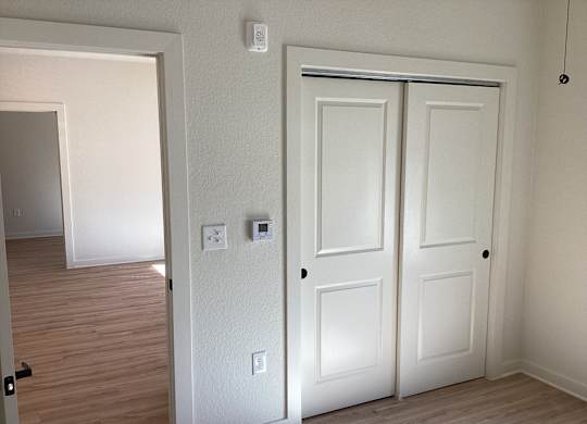 A white door is on the right and a white wall is on the left.