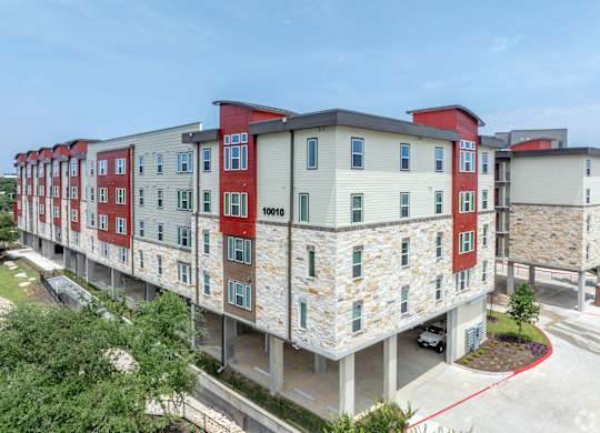 A multi-story building with a mix of red, white, and grey exterior.