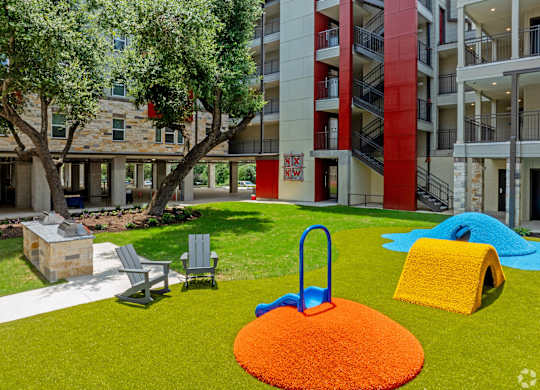 A playground area with a slide, swings, and a ball pit.
