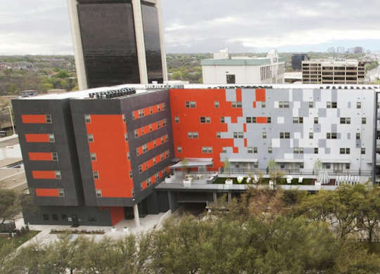 A modern building with a combination of orange and white sections.