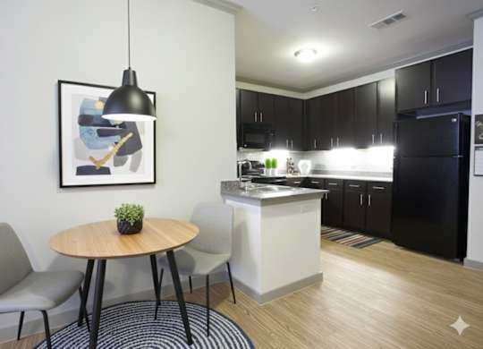 A modern kitchen with a dining table and chairs.
