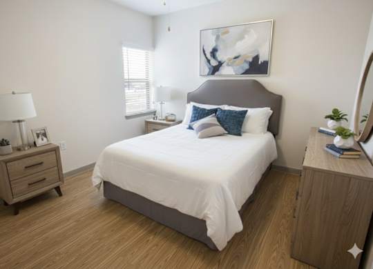 A bedroom with a bed, nightstand, and a painting on the wall.