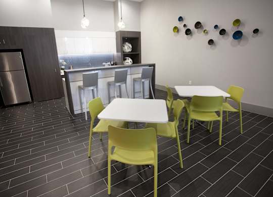 A kitchen with a table and chairs.