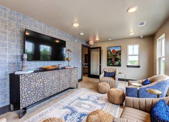 A living room with a patterned wall and a blue and white rug.
