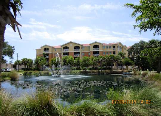 A building with a fountain in front of it.
