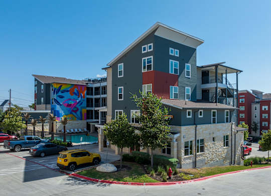 A modern building with a colorful mural on the side.