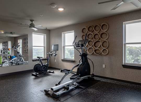 A spacious home gym with a variety of exercise equipment.