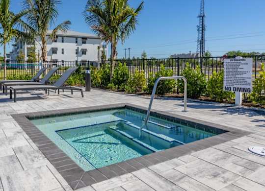 A pool with a no diving sign in front of a building.