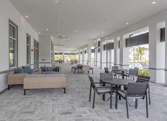 A spacious room with a long table and chairs.