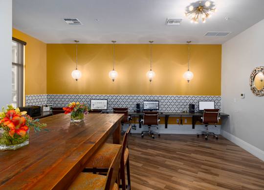 A conference room with a long table and chairs.