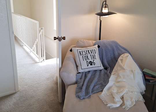 A small bed with a pillow that says "Reserved for D&B" on it.
