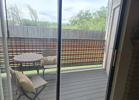 A patio with a table and two chairs.