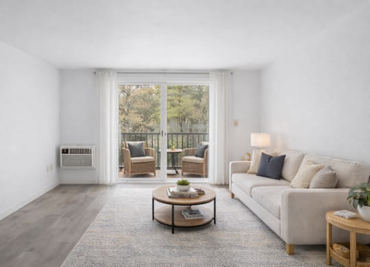 A living room with a couch, chairs, and a coffee table.