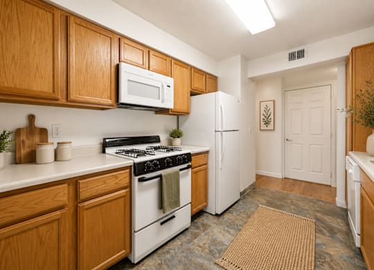 A kitchen with wooden cabinets and white appliances.