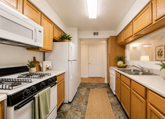A kitchen with wooden cabinets and a white refrigerator.