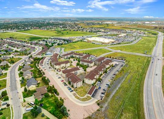 A suburban neighborhood with a large apartment complex in the foreground.